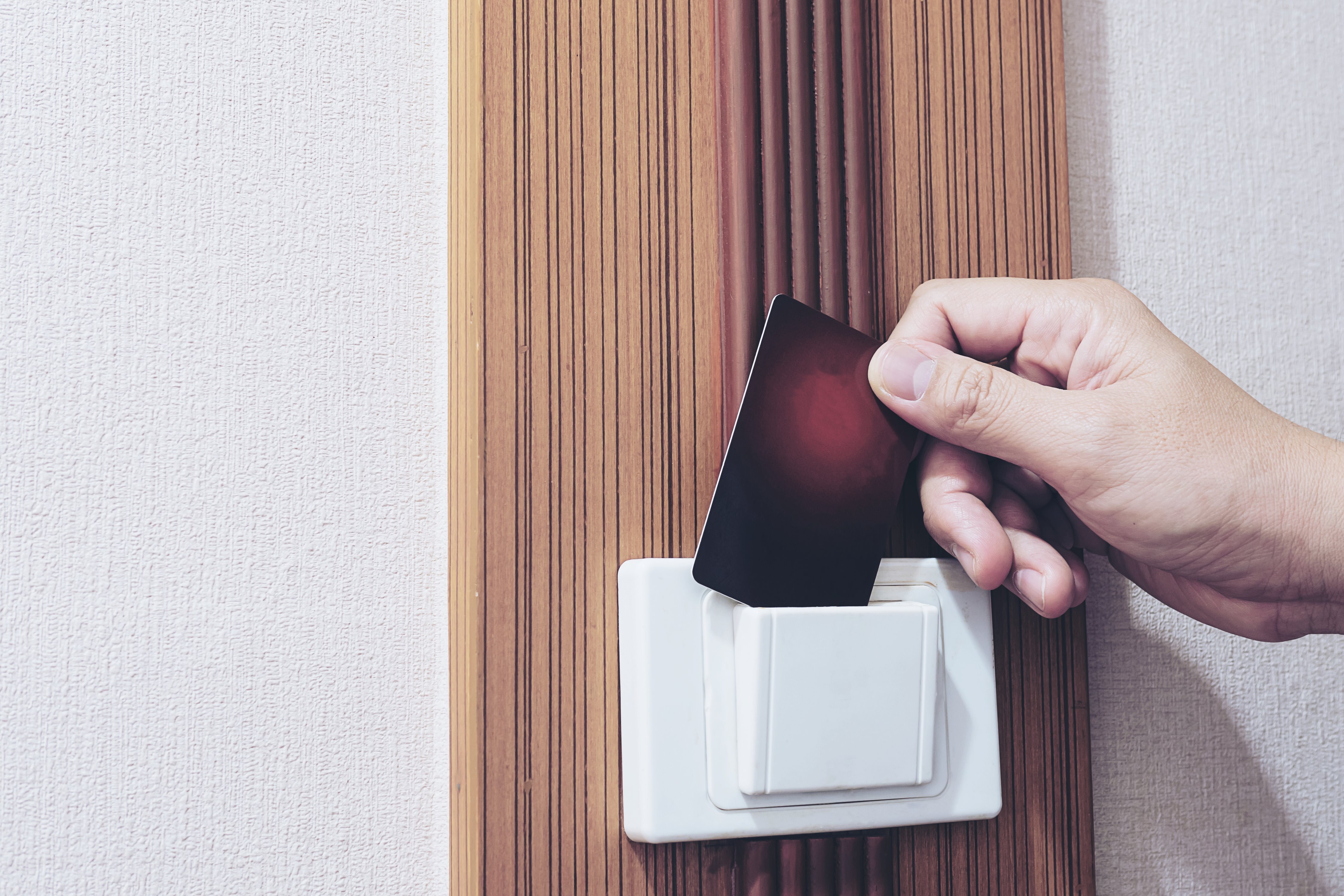 employee inserting keycard into commercial door access reader