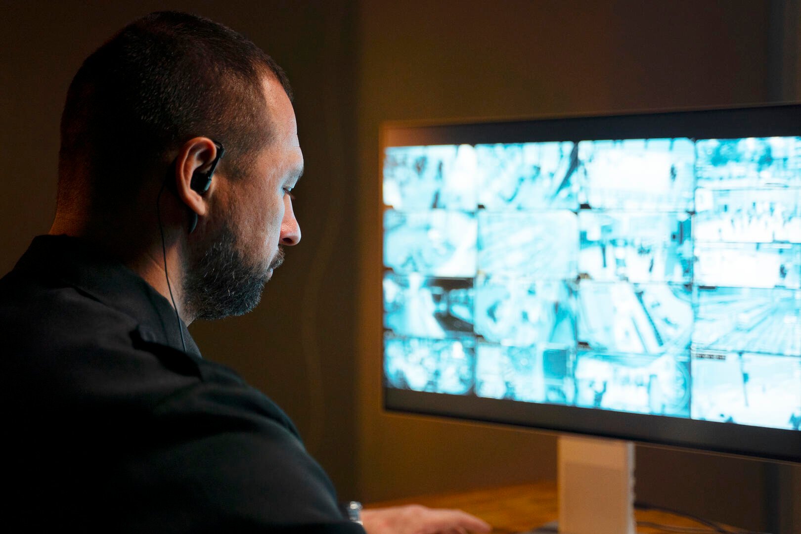 security professional monitoring commercial surveillance camera system