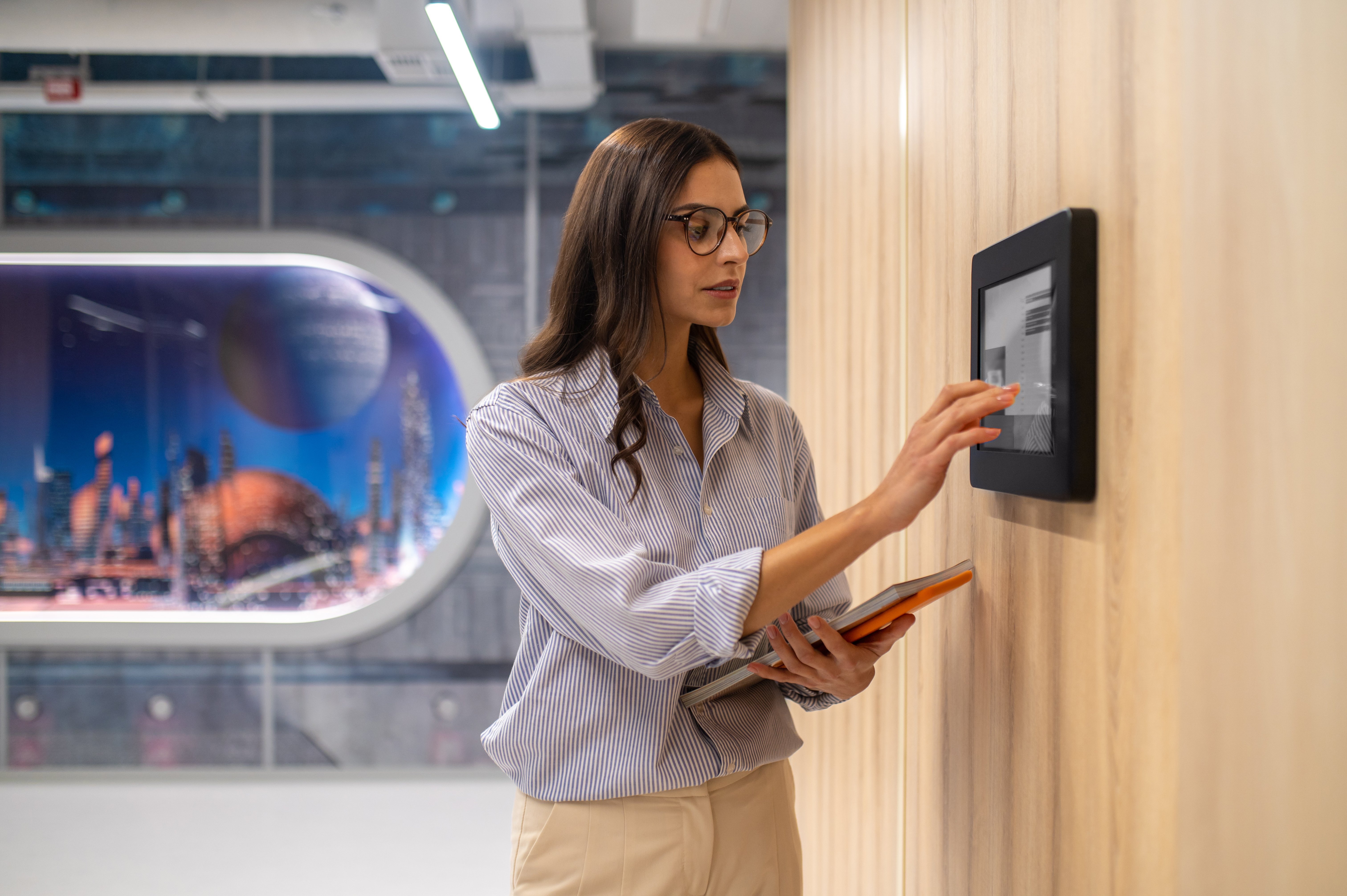 employee using wall mounted access control panel in office building